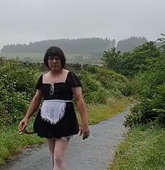 Femme de ménage travestie dans une voie publique sous dispirit pluie